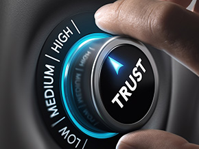 Hand turning a dial to 'High Trust,' emphasizing the importance of trust in cybersecurity solutions and maintaining customer confidence.