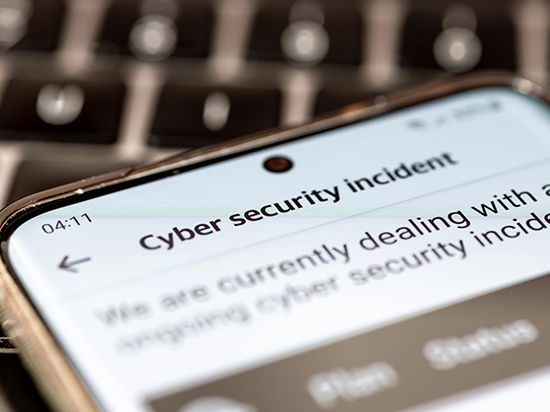 Smartphone screen with cybersecurity incident alert, highlighting the importance of training employees to recognize and respond to threats