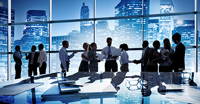 Corporate professionals in a modern office building, representing tailored cybersecurity solutions for commercial enterprises, with a cityscape of corporate buildings in the background.